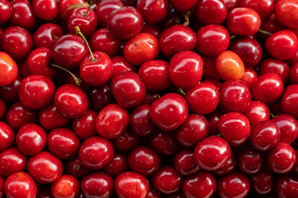 Fresh acerola cherries, the whole-food vitamin C source in Cosmic Doctor Double C. Priority: essential. This is the image that carries the food-first argument visually.