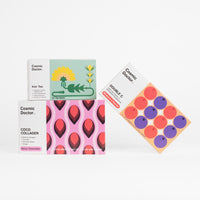 Collection of Cosmic Doctor product boxes of Coco Collagen, Double C and Iron Tea on a white background